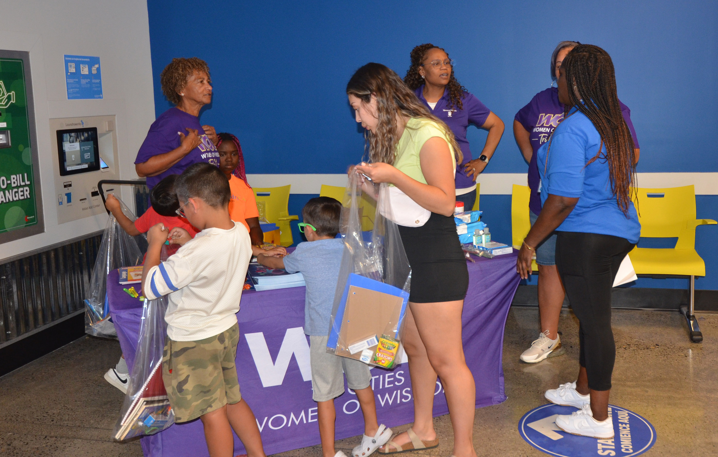 Neighbors meeting community resource volunteers at The Wash
